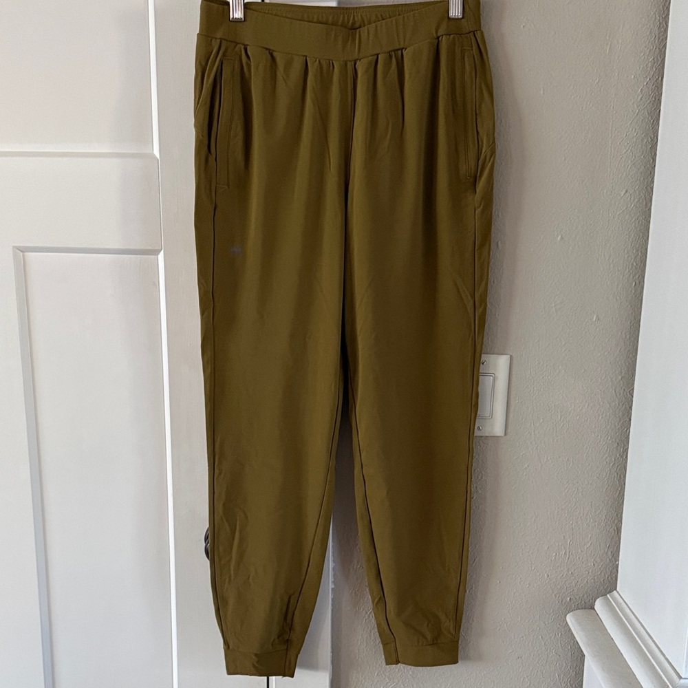 Women’s Janji running pants, olive green.